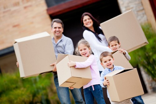 Local removals team carrying furniture from a student house